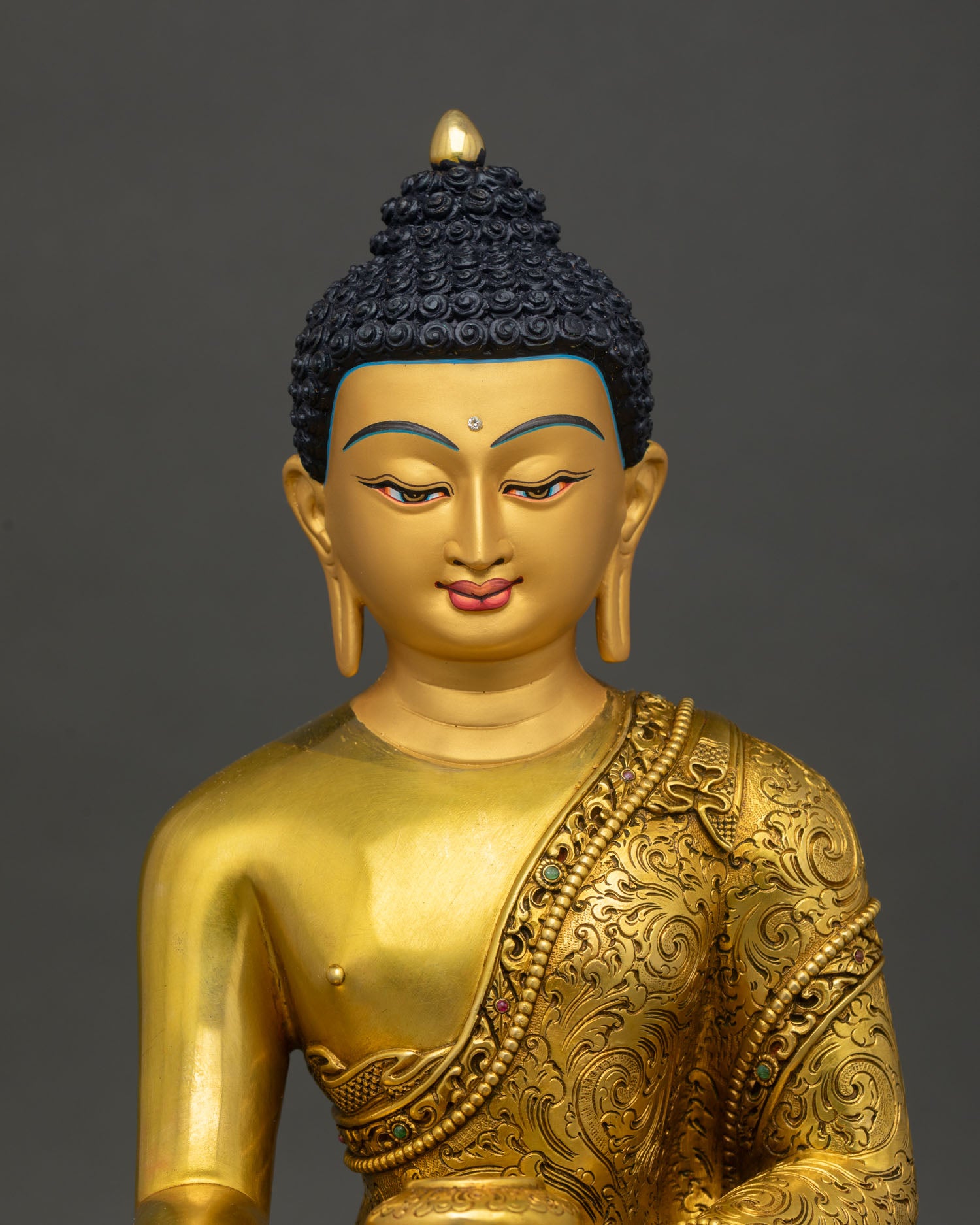 Buddha sculpture, featuring a serene gold painted face and intricate floral carvings