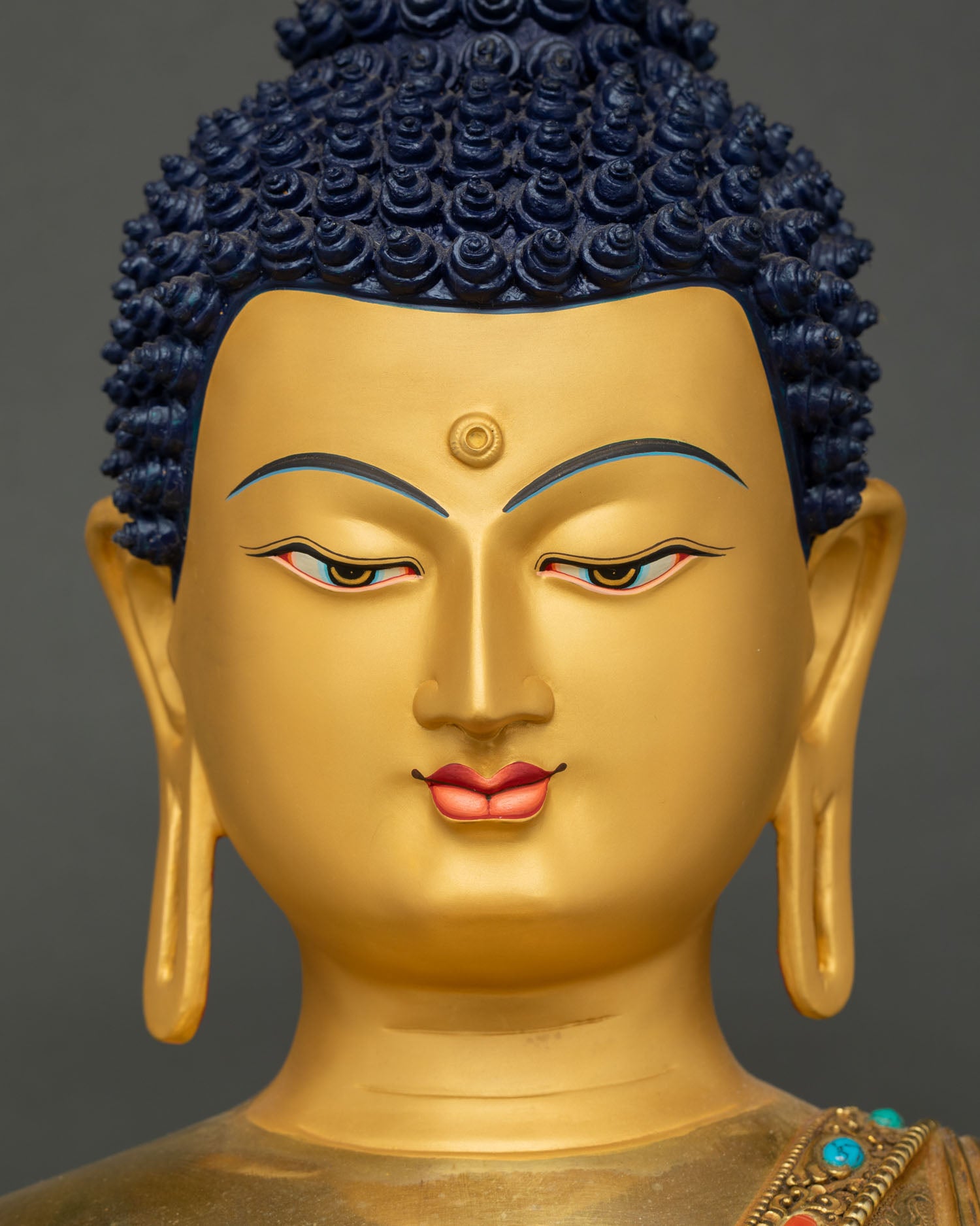 Buddha Shakyamuni Statue golden face front view with elongated earlobes detail