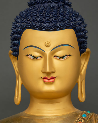 Buddha Shakyamuni Statue golden face front view with elongated earlobes detail