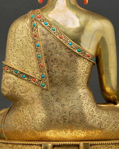 Buddha Shakyamuni Statue monk robe decoration and inlaid stones detail close-up