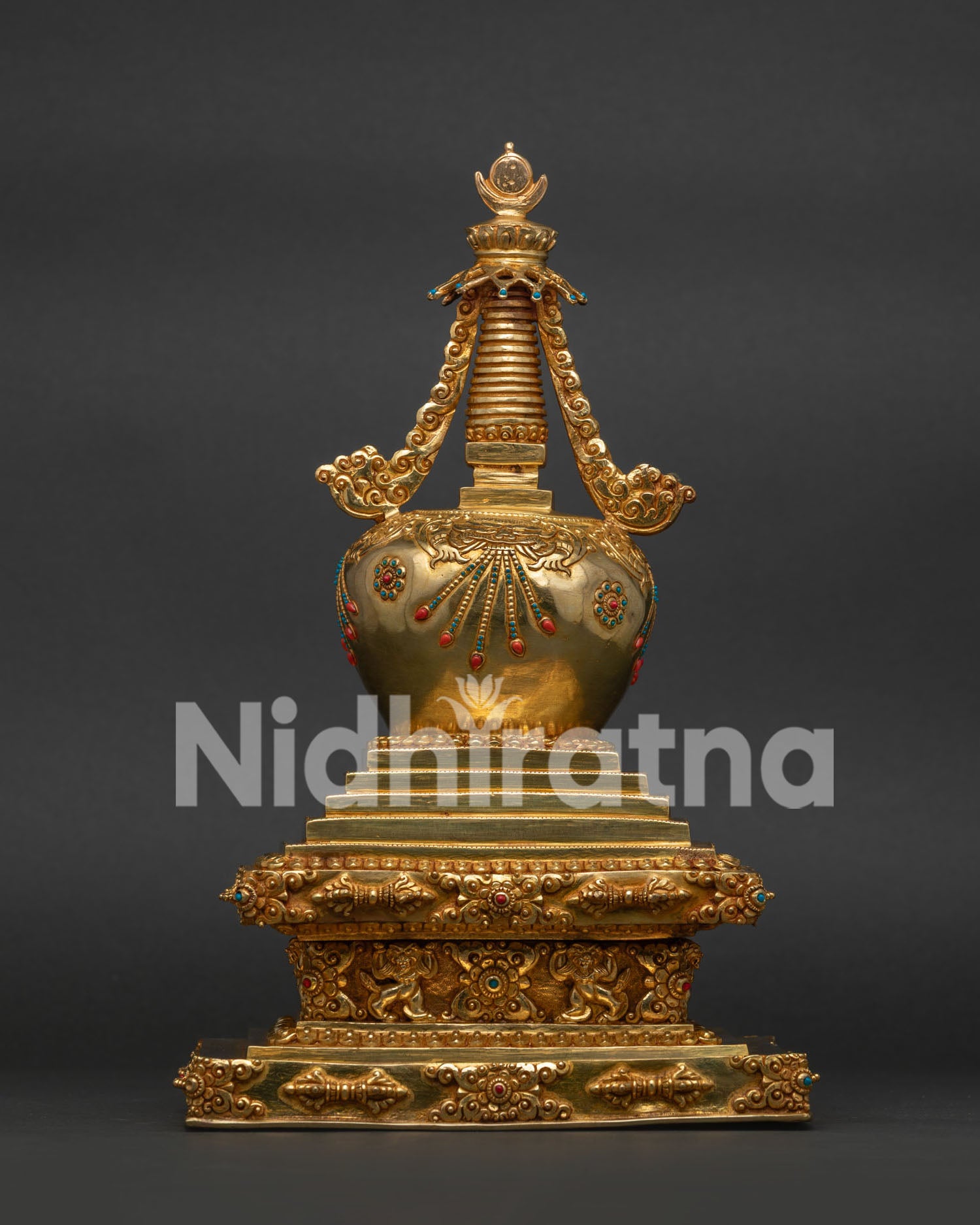 Buddha stupa with intricate gold details and gemstone adornments