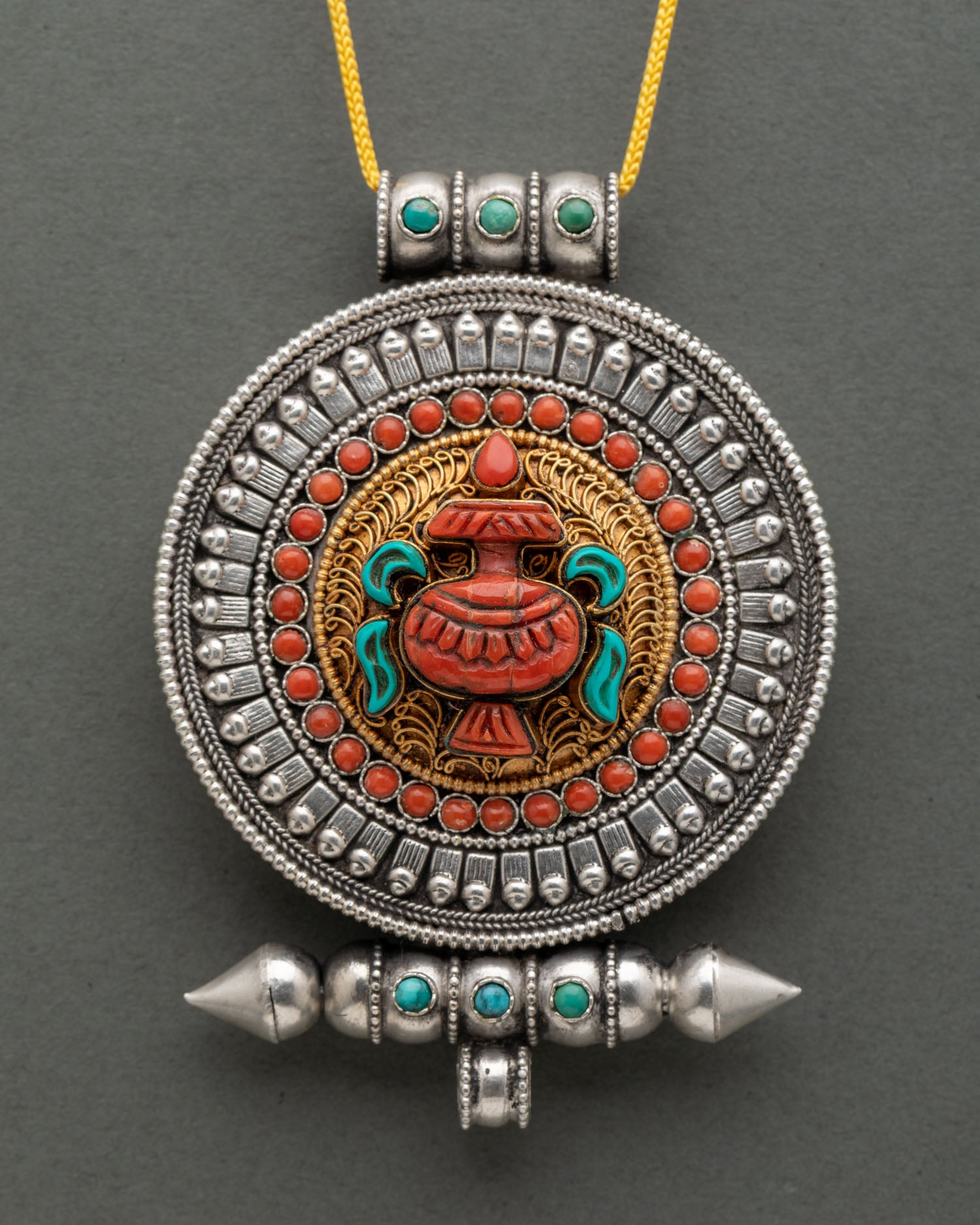 Buddhist Ghau Mala adorned with coral and turquoise stones featuring a sacred Treasure Vase symbol