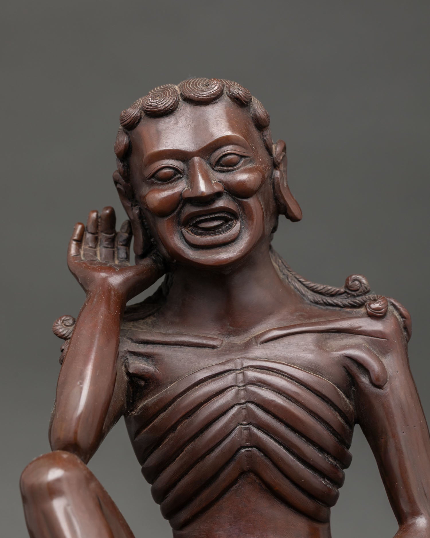 Buddhist master Milarepa sculpture with listening gesture