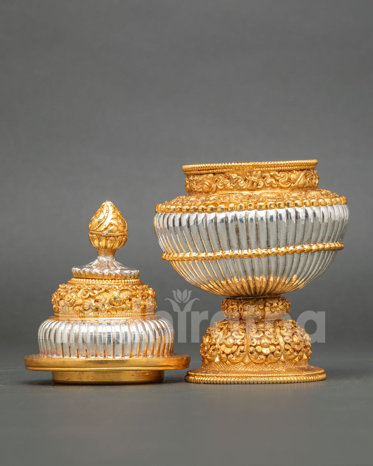Buddhist rice offering vessel made from copper with intricate floral engravings and traditional metalwork