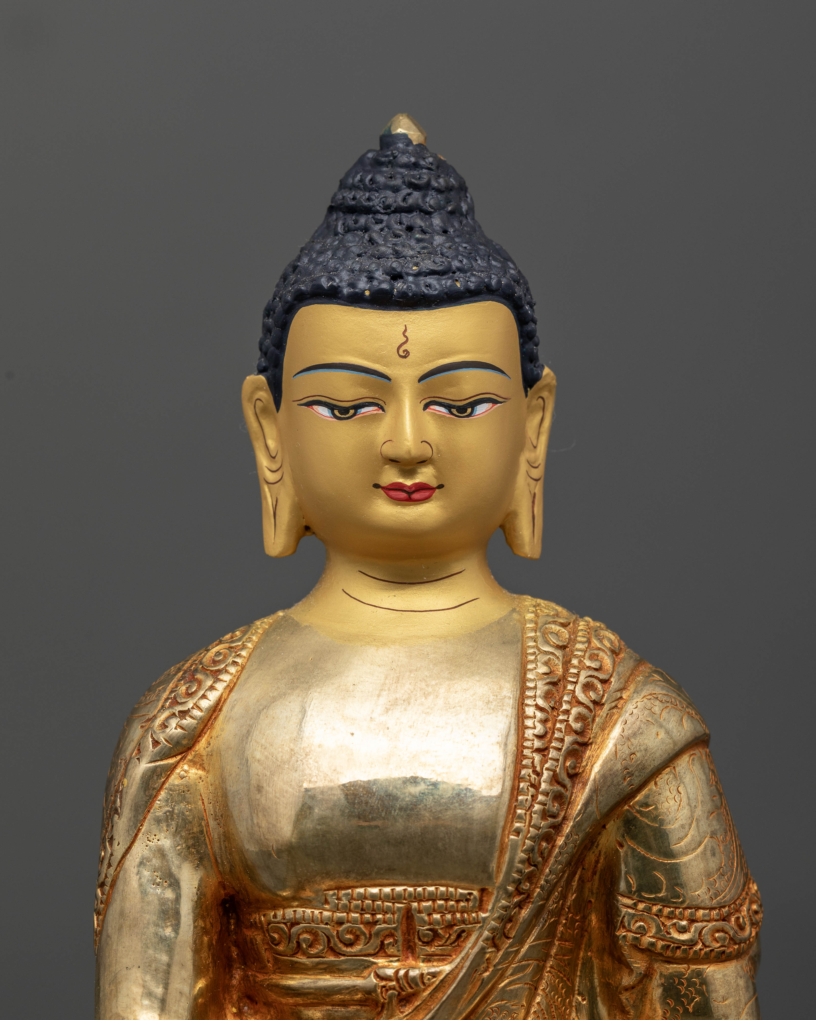 Buddhist Shakyamuni Buddha statue with floral robe motifs and gold painted face
