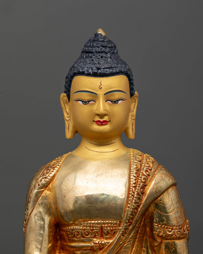 Buddhist Shakyamuni Buddha statue with floral robe motifs and gold painted face