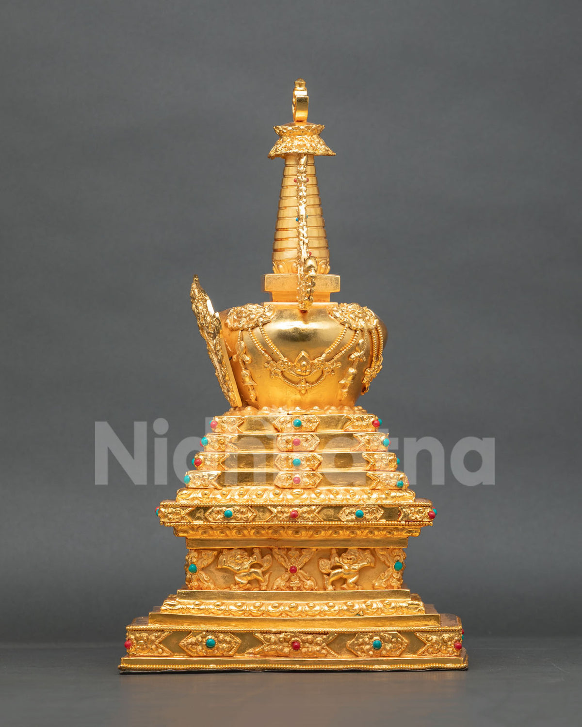 Buddhist Stupa sculpture adorned with semi-precious stones and intricate traditional metalwork