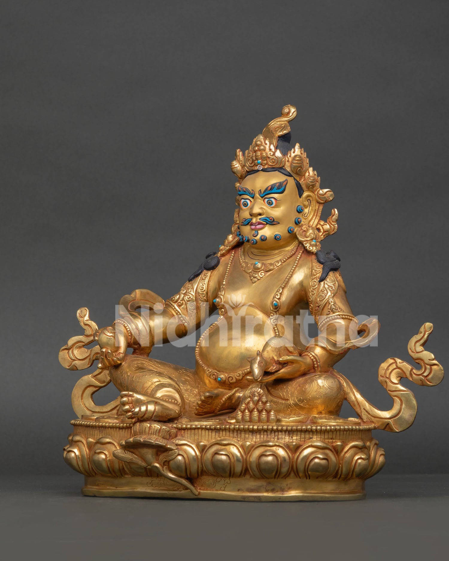 Buddhist wealth deity Dzambhala holding a jewel spitting mongoose and citron fruit symbolizing prosperity