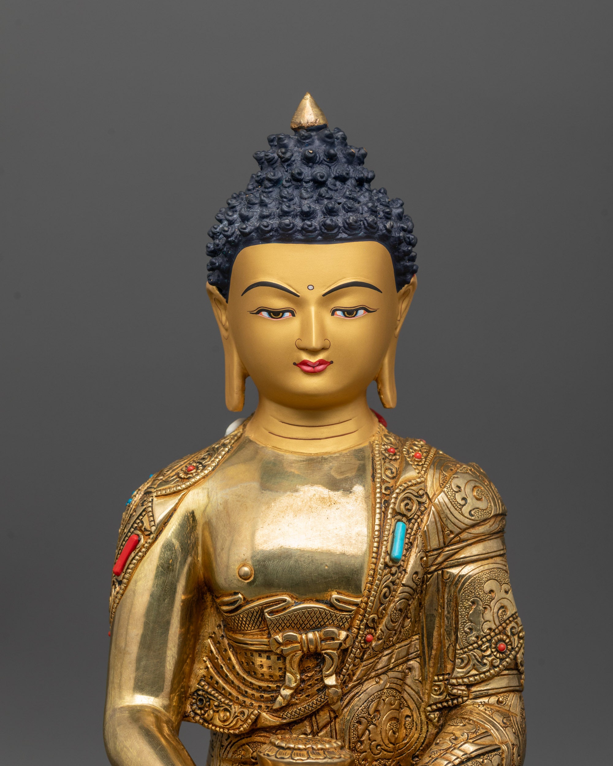 Close-up of Amitabha Buddha robe details with ashtamangala symbols and semi-precious stones