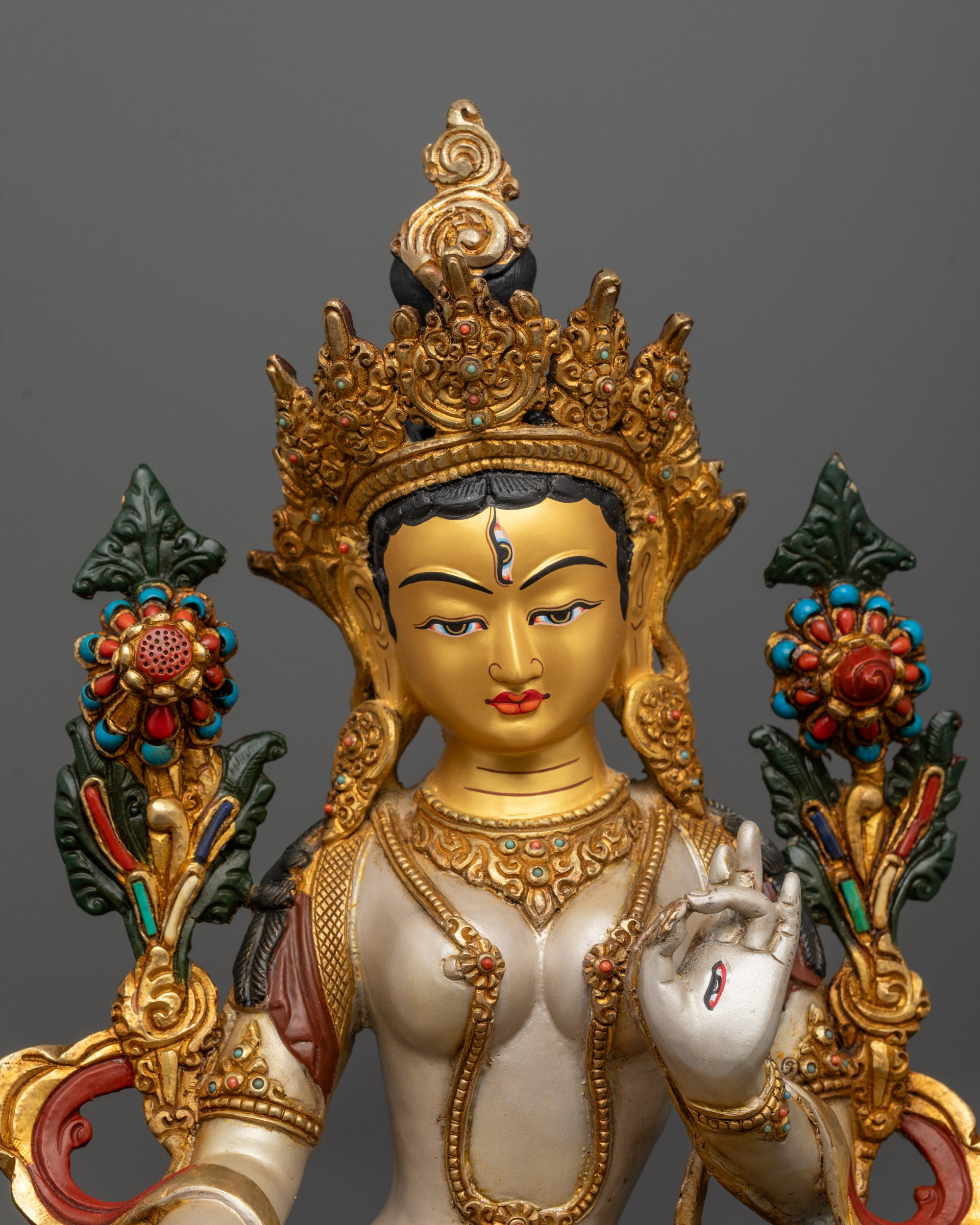 Close-up of White Tara Bodhisattva with seven eyes and five-jewel crown