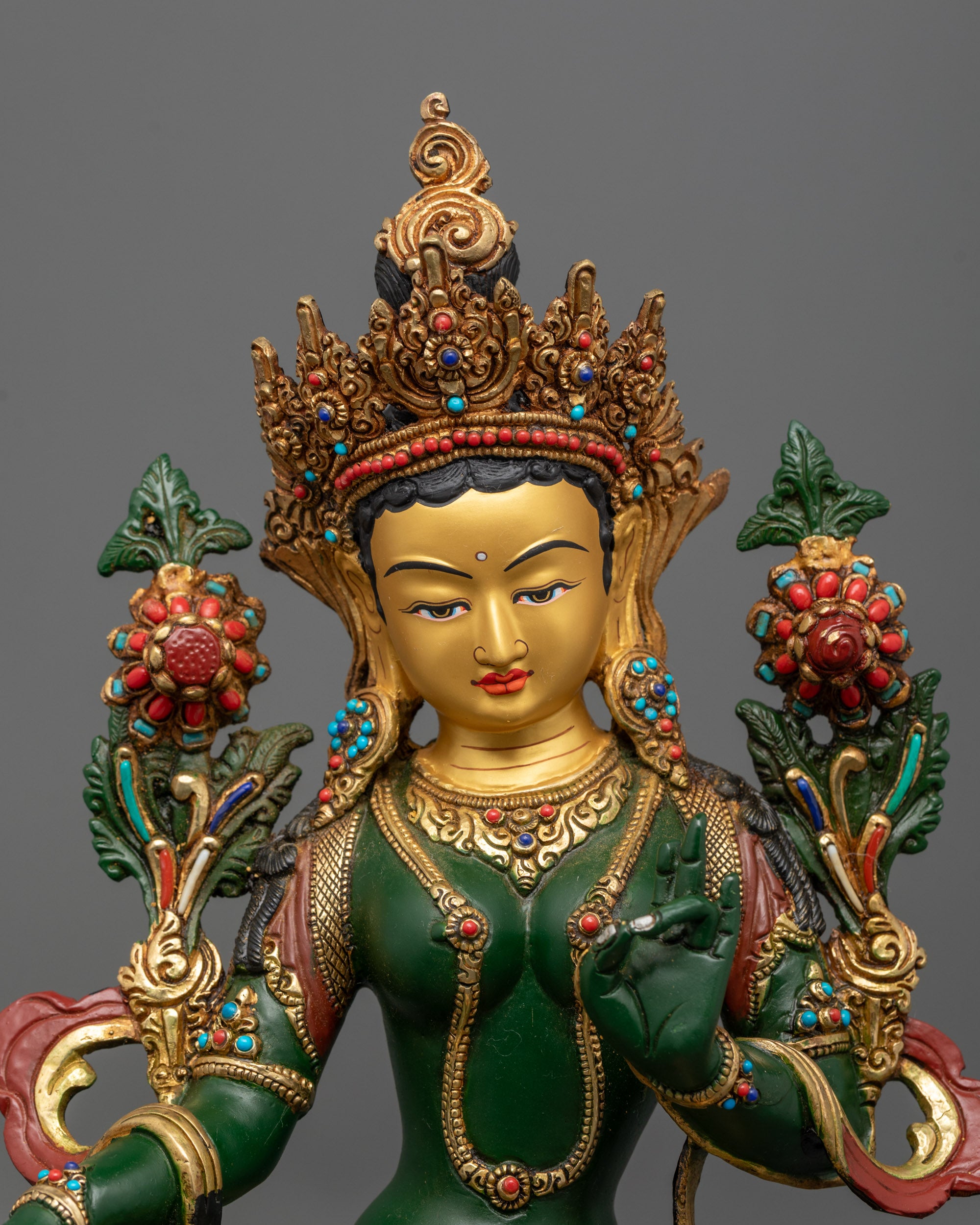 Close-up of Green Tara Bodhisattva in varada mudra with semi-precious stone adornments