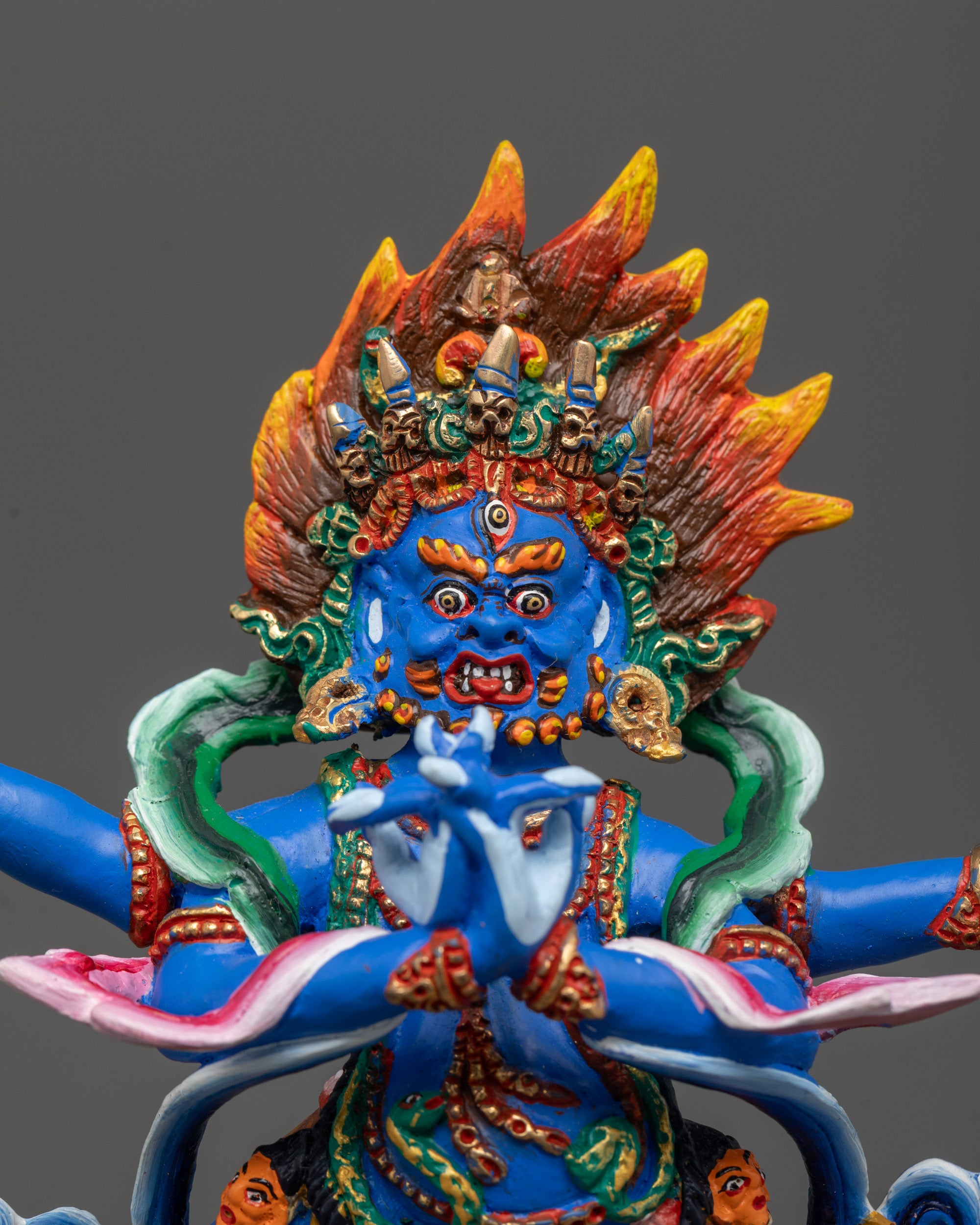 close up of vajrapani statue jewelry patterns and vibrant acrylic detailing