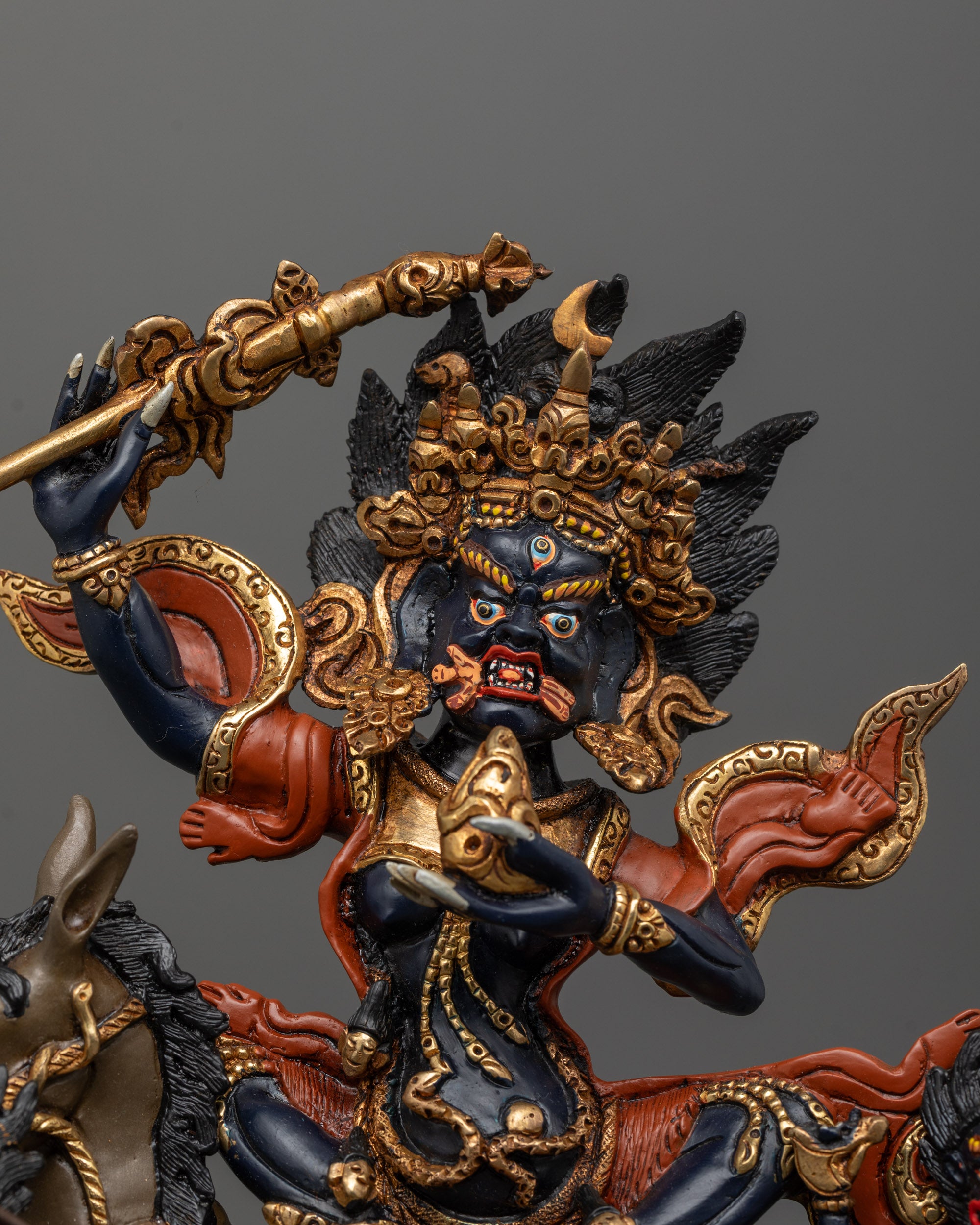 Close up of Palden Lhamo statue showing intricate crown, jewelry, and four arms