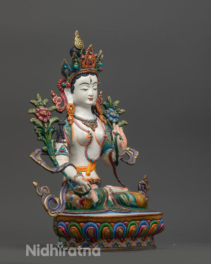 Side view of White Tara statue highlighting floating robe and utpala flower