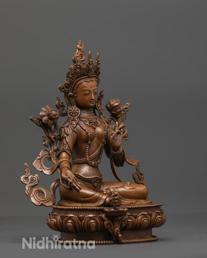 Side view of Oxidized Green Tara Statue with five-jeweled crown and carved lotus base