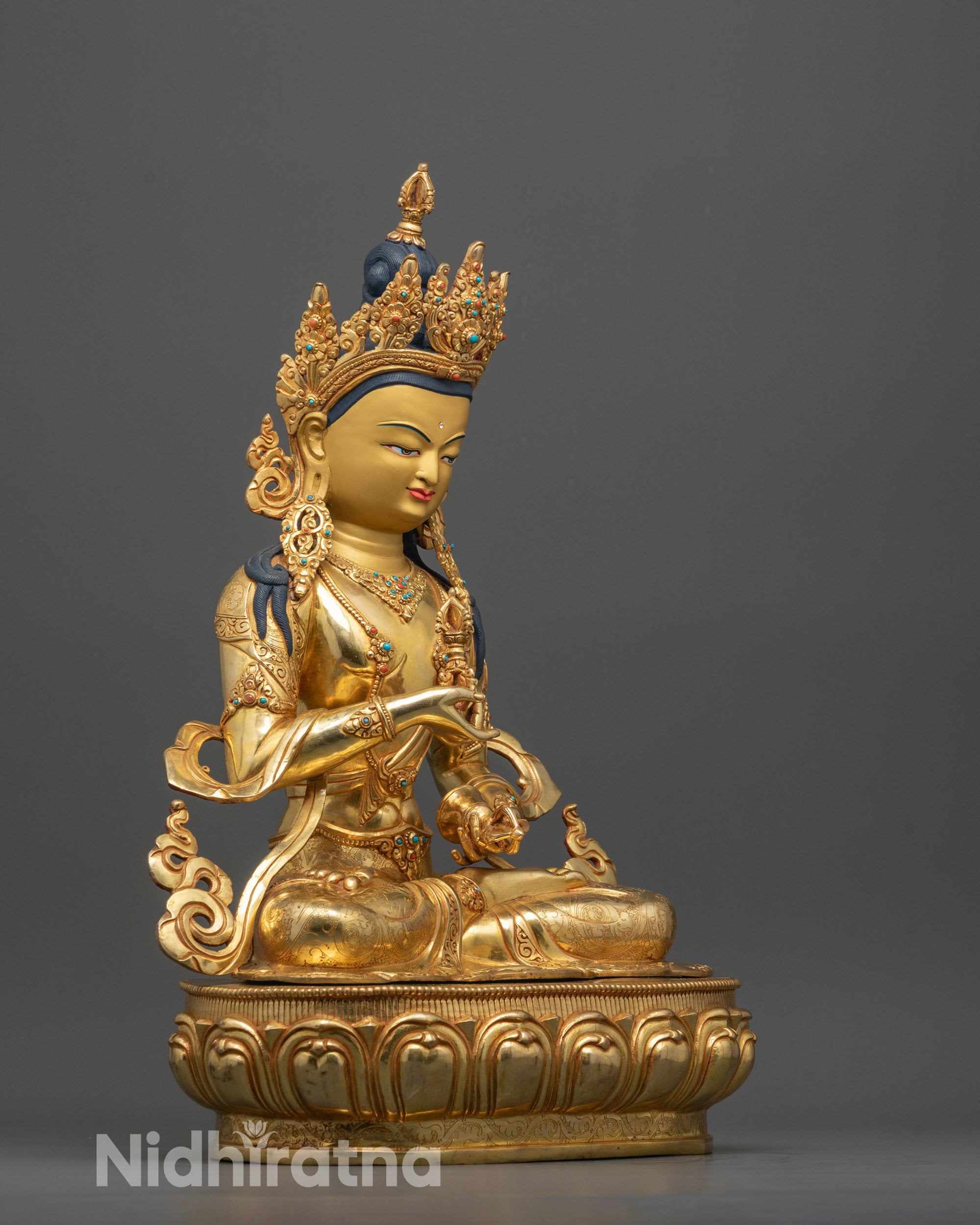 Side angle showing intricate robes, dharma wheel, and deer carvings on Vajrasattva Statue

