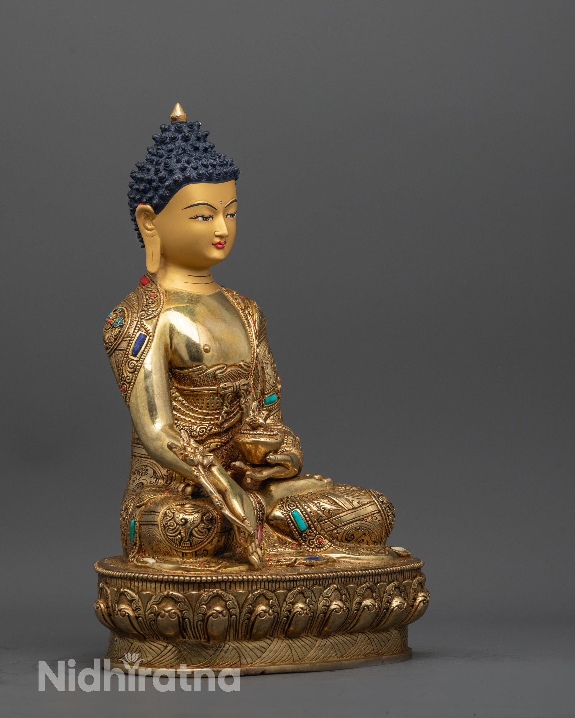 Side view of Medicine Buddha Statue showing monk’s bowl and myrobalan plant