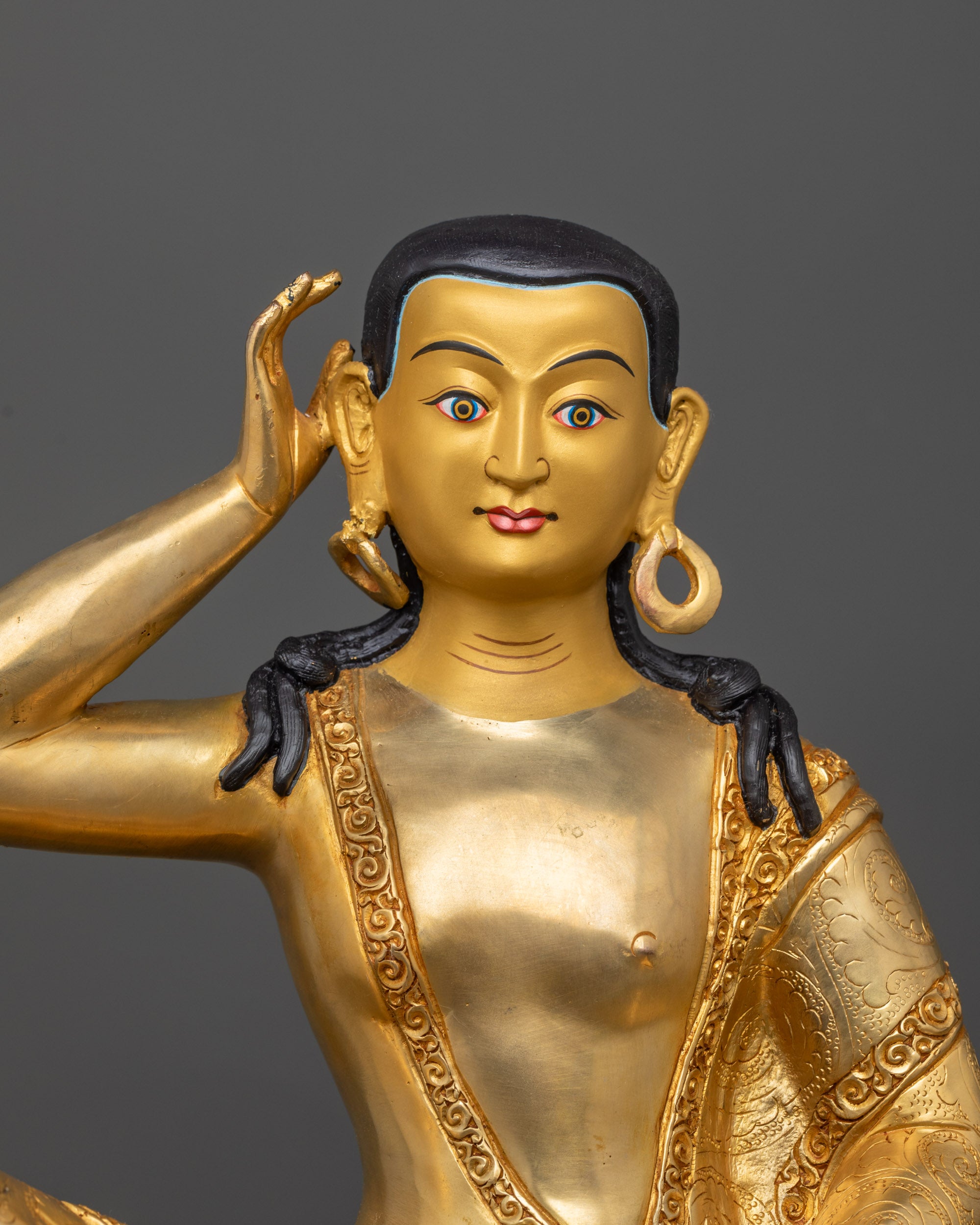 Close up of Milarepa Statue showing gold fire-gilded body and detailed begging bowl