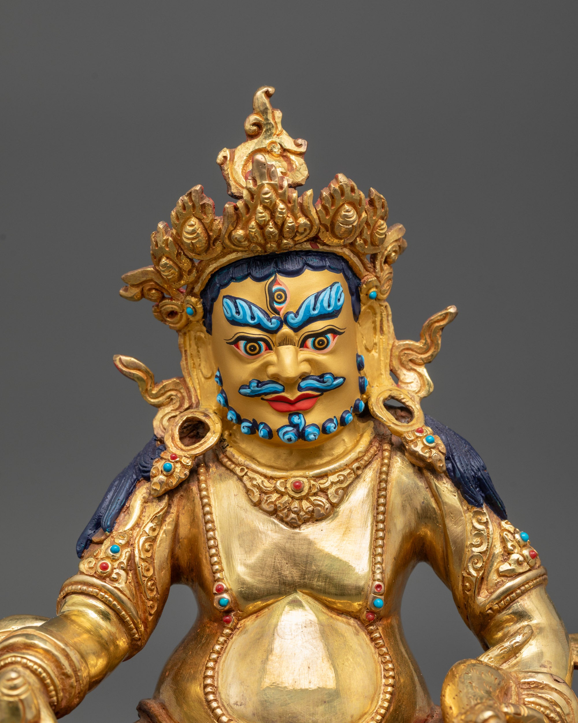 Close-up of Dzambhala Statue’s jewel-spitting mongoose with gold-plated finish
