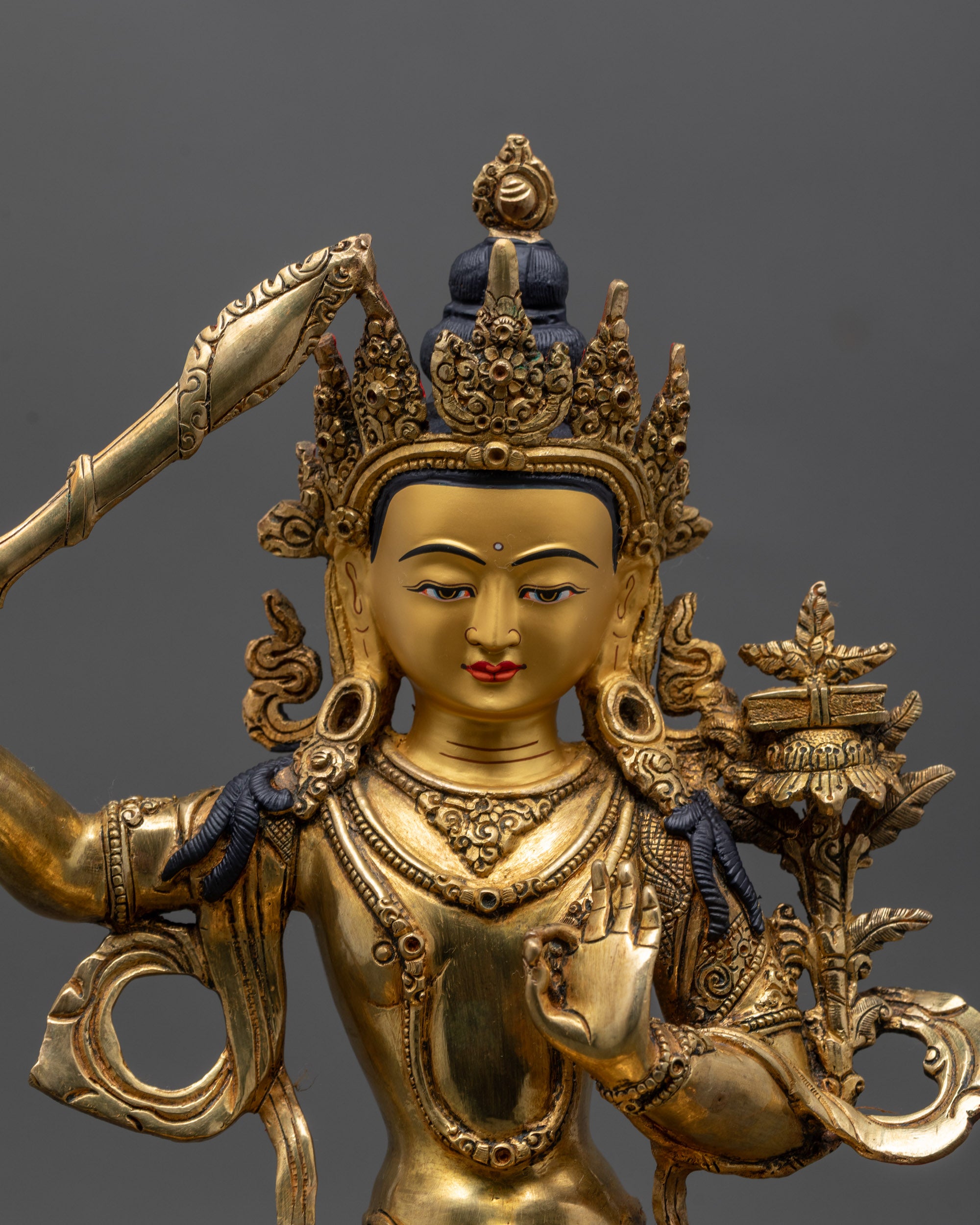 Close up of Monju Bosatsu sculpture showing intricate detailing and 24K gold gilding
