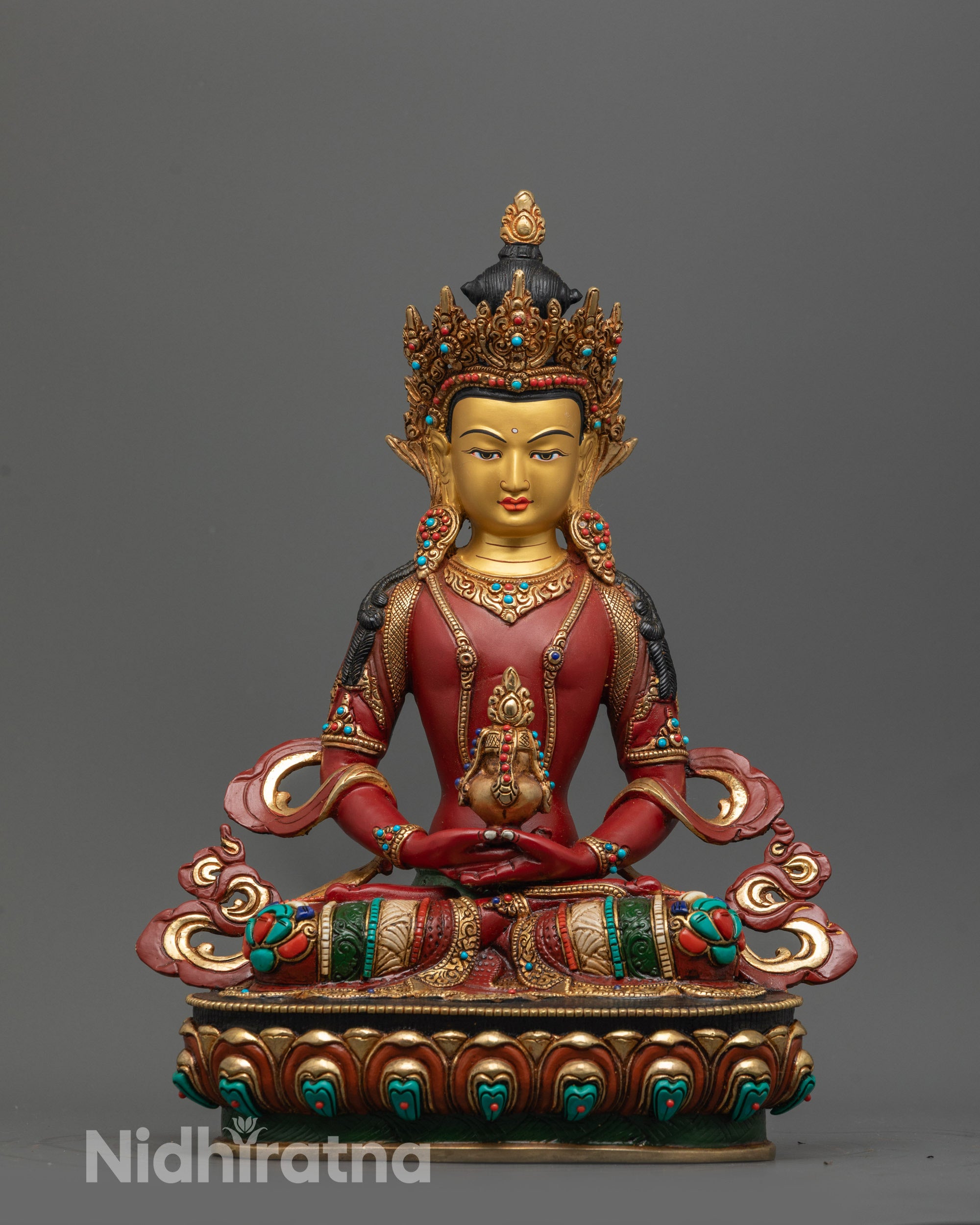 front view of red Amitayus statue with gold-plated face and lotus base