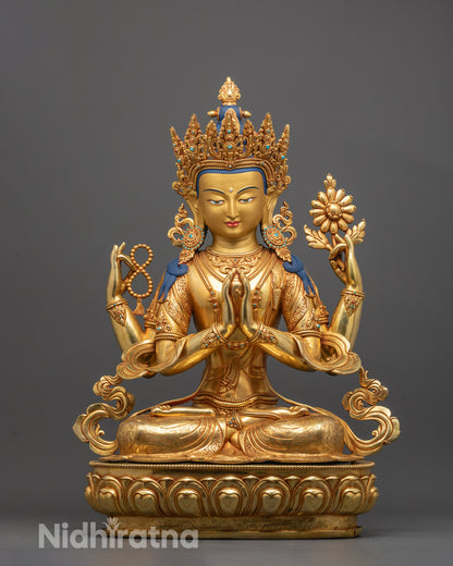 Front view of Chenrezig statue with gold gilding and four arms holding sacred objects