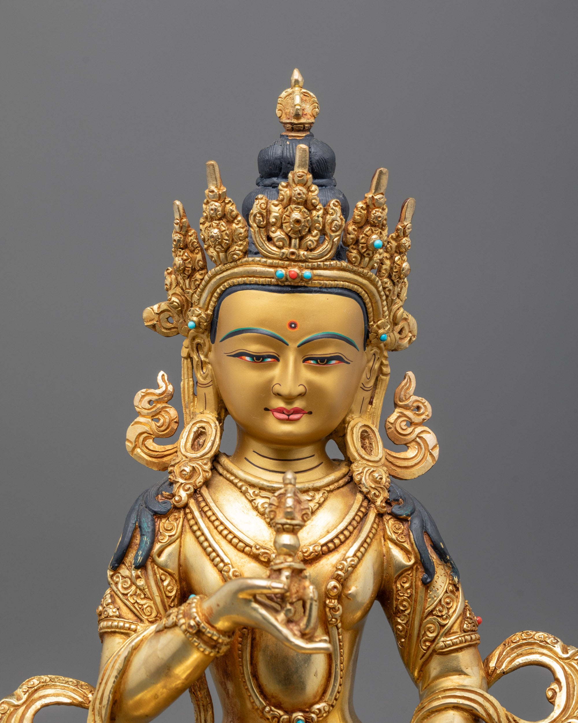Close-up of Vajrasattva Buddha statue showing 24k fire gold gilded copper