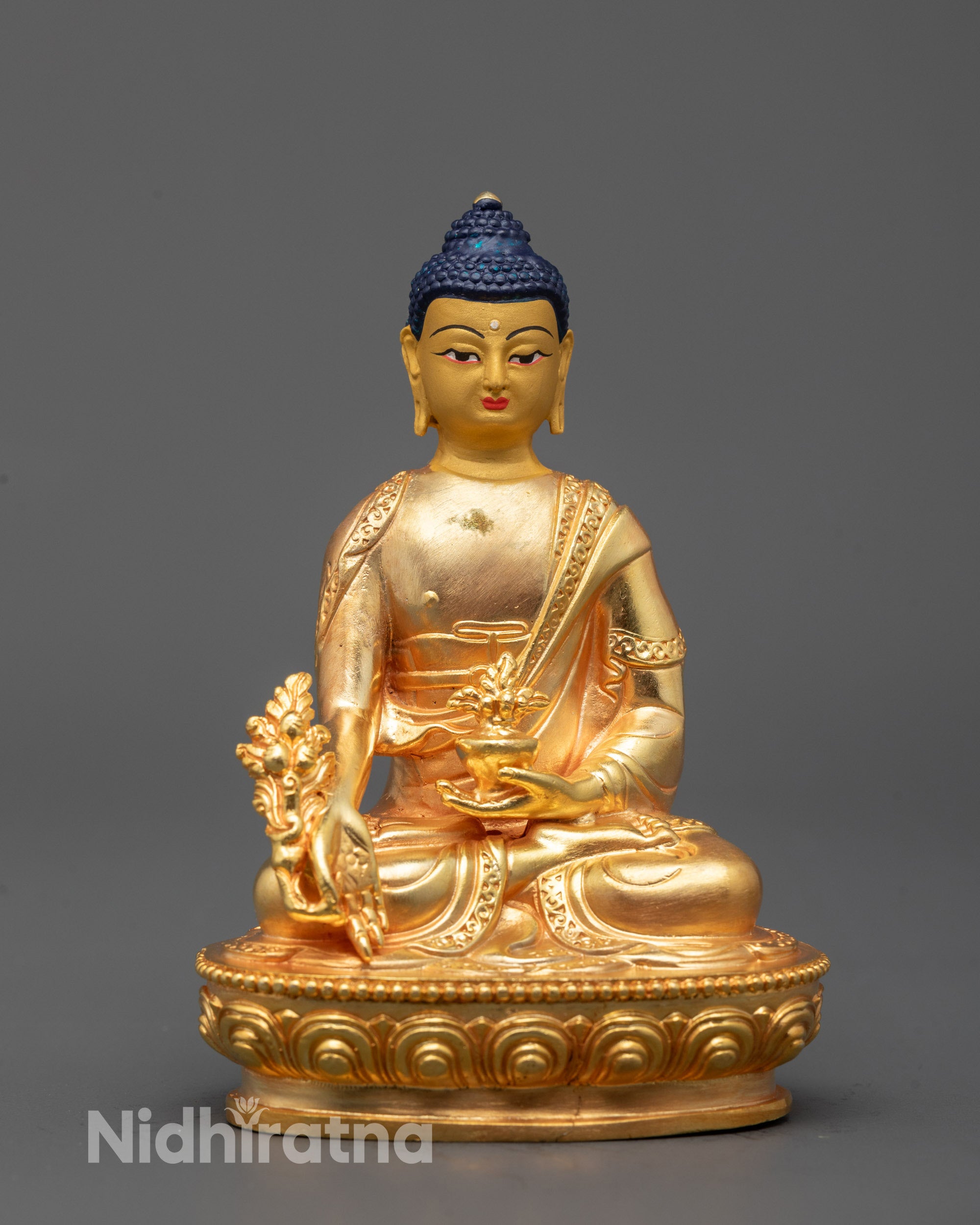 front view of machine-made medicine buddha statue with 24k gold-coated face and bowl