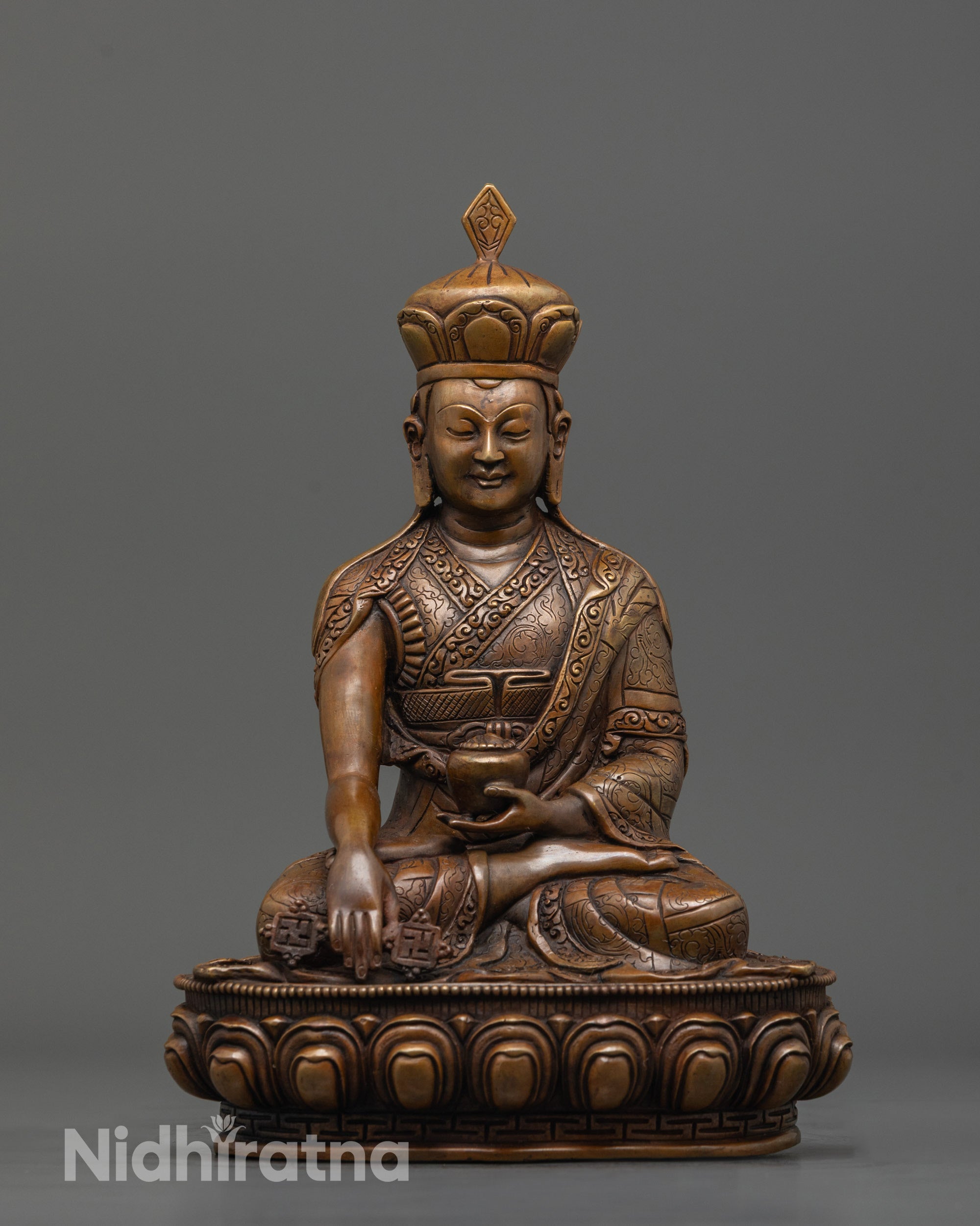 front view of oxidized karmapa statue with lineage crown and earth-touching mudra
