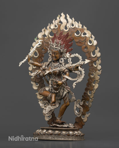 Chemically oxidized Kurukulla statue standing on a human figure with detailed silver plated accents.