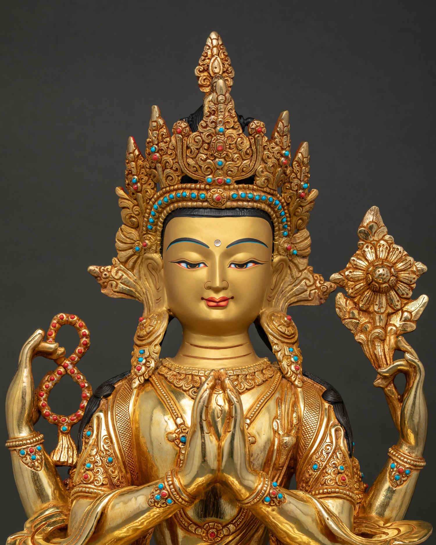 chenrezig avalokiteshvara statue with turquoise coral stone details and gold face