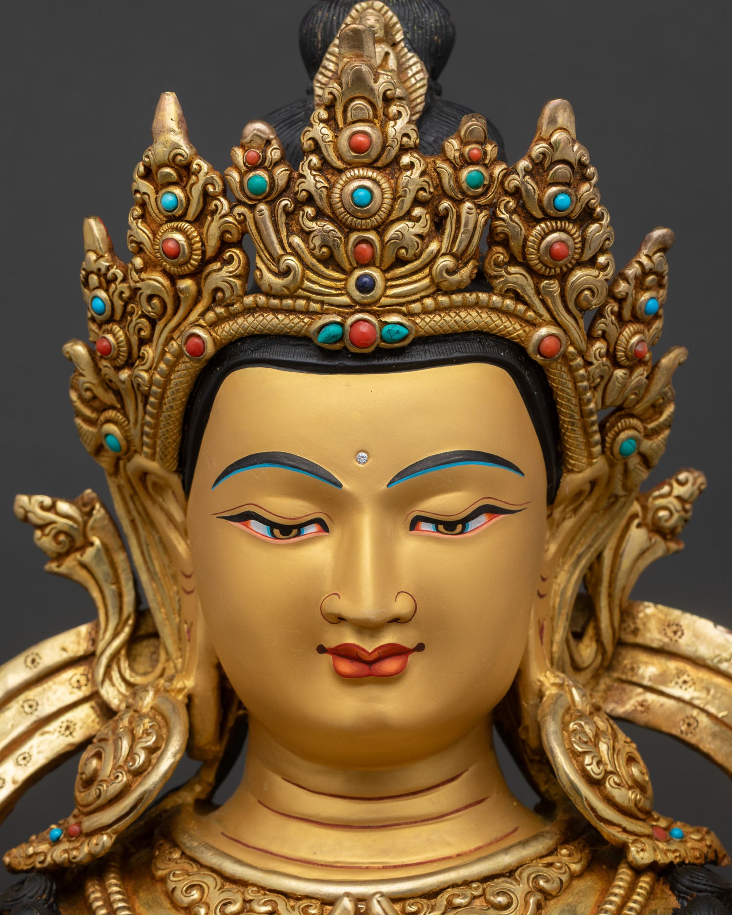 chenrezig face close up gold painted serene expression avalokiteshvara statue
