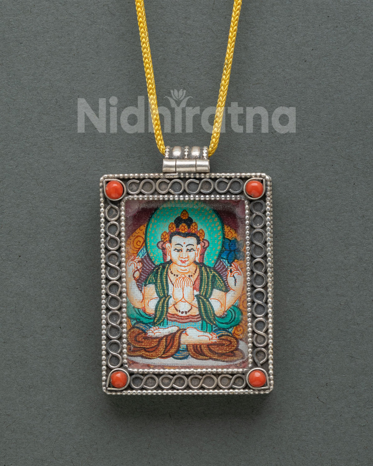 Chenrezig locket silver buddhist pendant with coral stones and floral filigree.