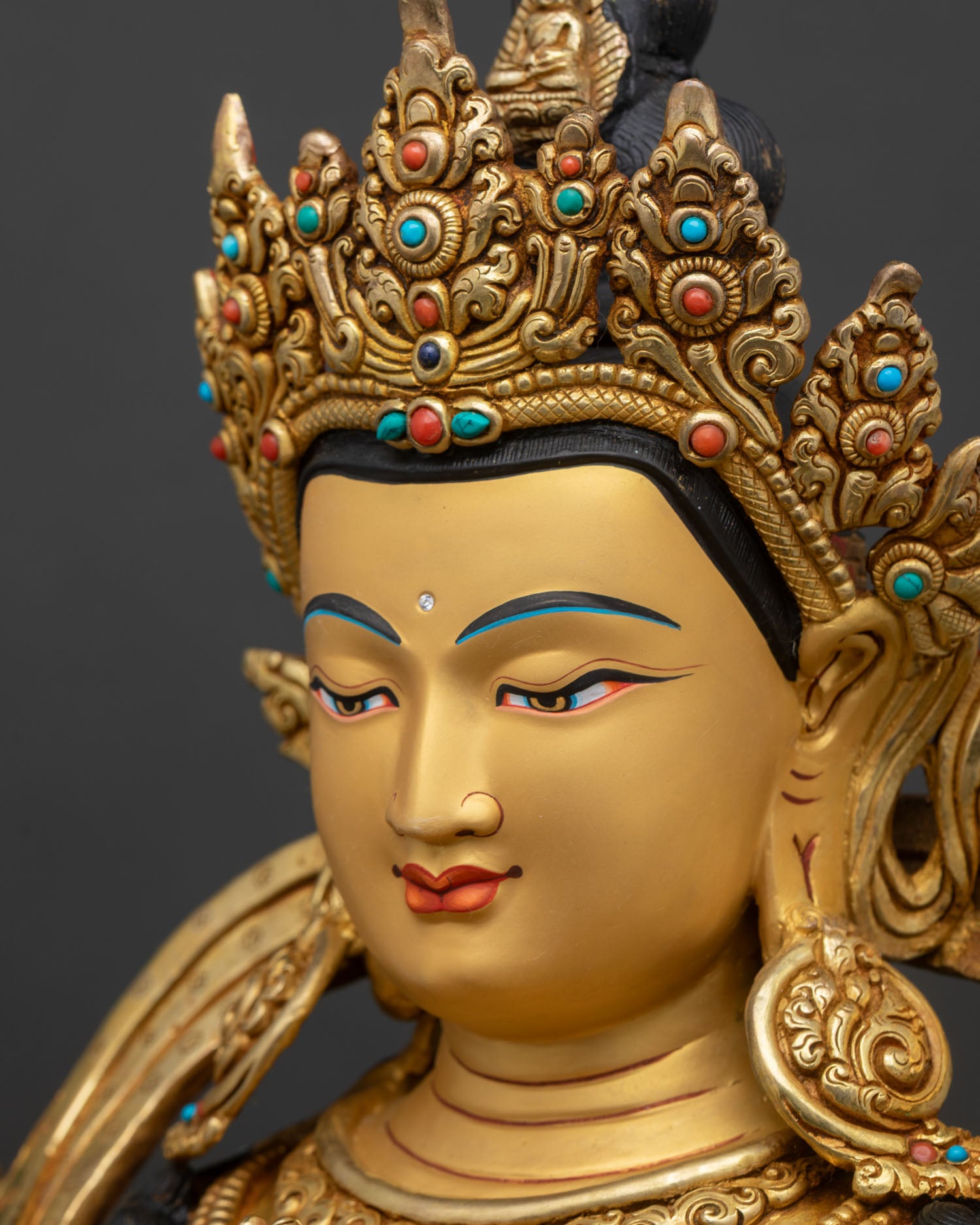 chenrezig side face close up gold painted features compassionate expression