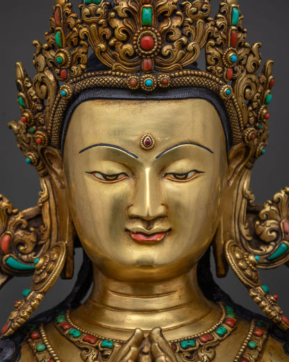 chenrezig statue face close up gold painted serene expression with jeweled crown patan nepal