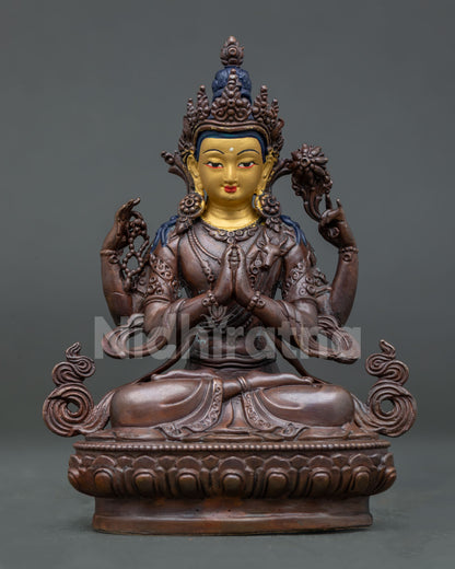 Chenrezig statue handcrafted by Newari artisan from Patan Nepal with oxidized copper finish and 24k gold painted face.