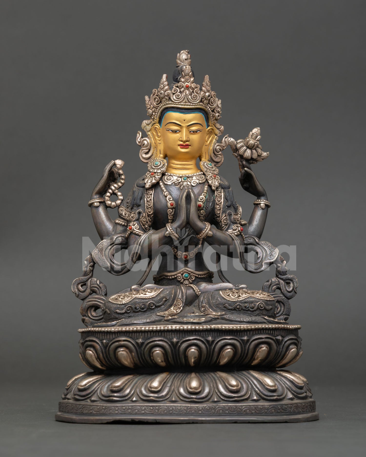 Front view of Chenrezig statue handmade copper Buddhist sculpture from Nepal oxidized silver plated finish Bodhisattva of compassion Himalayan art