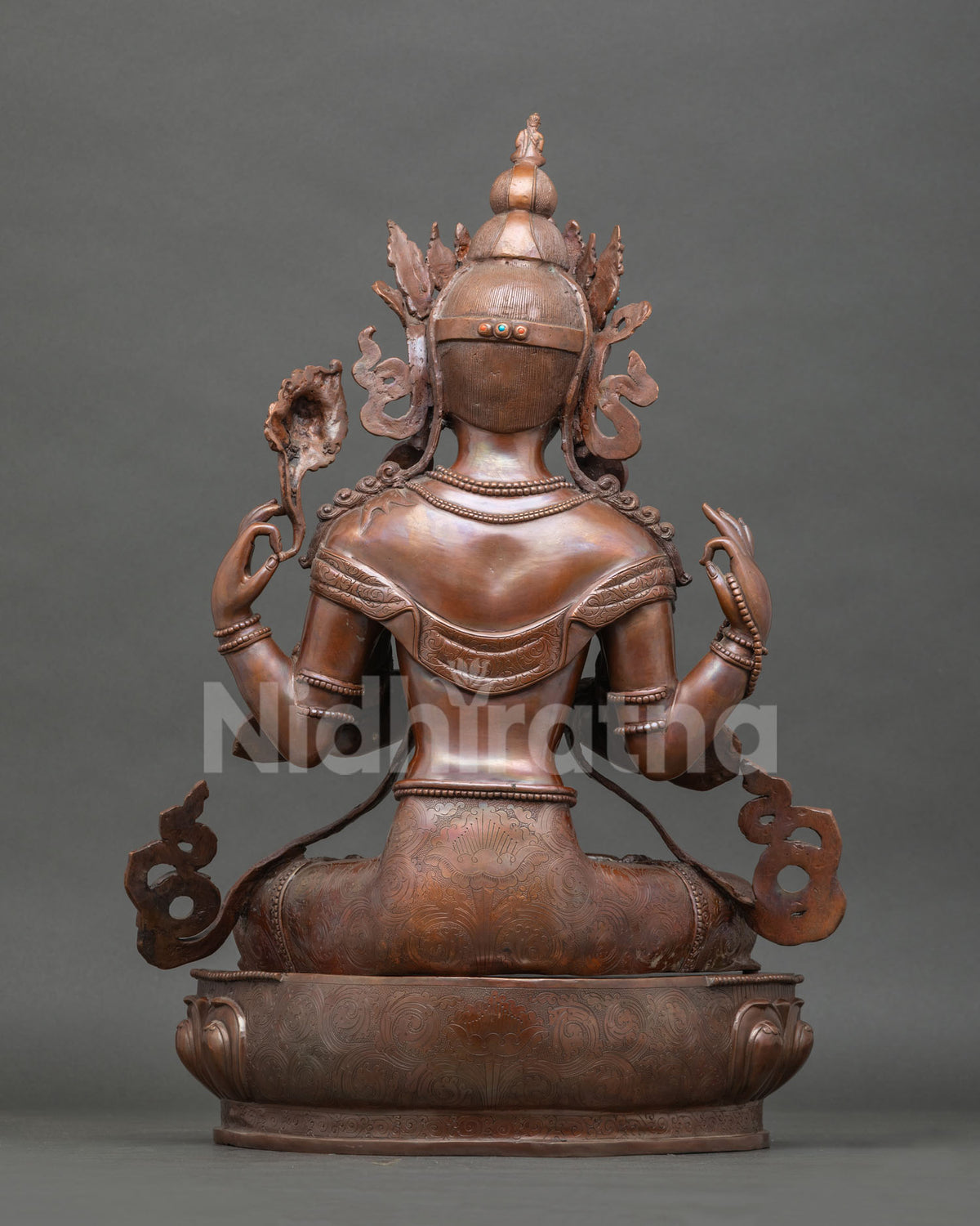 Chenrezig statue with anjali mudra crystal rosary and blooming lotus.