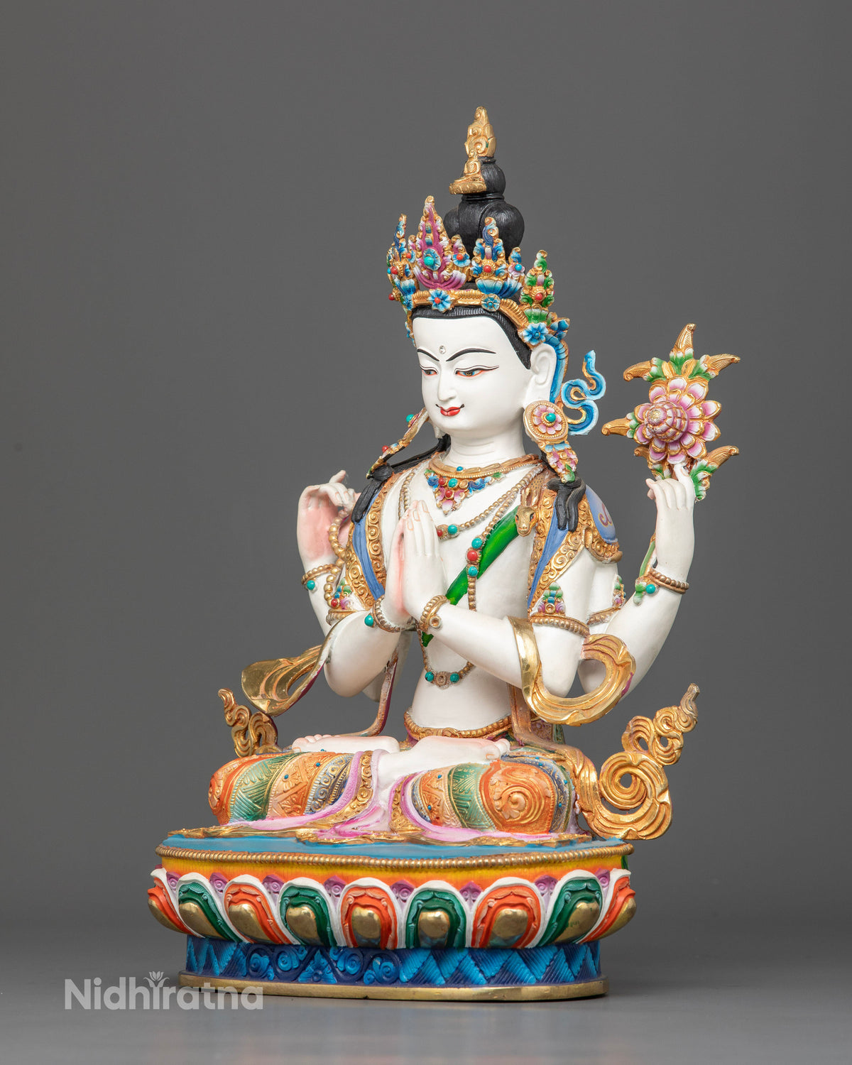 Chenrezig statue with crystal prayer mala and blooming lotus flower seated on lotus pedestal