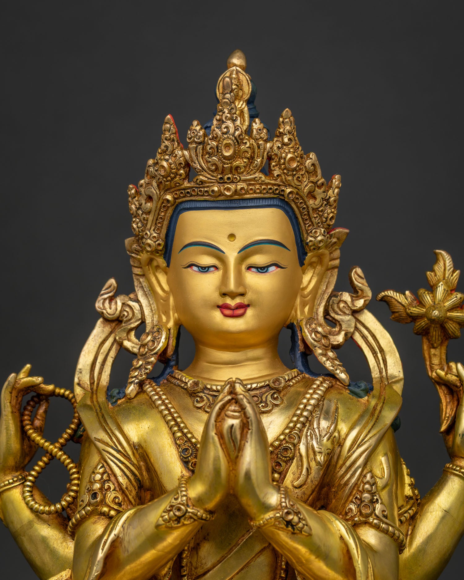 Close-Up of 24K Gold 4-Armed Chenrezig Statue with Anjali Mudra and Lotus