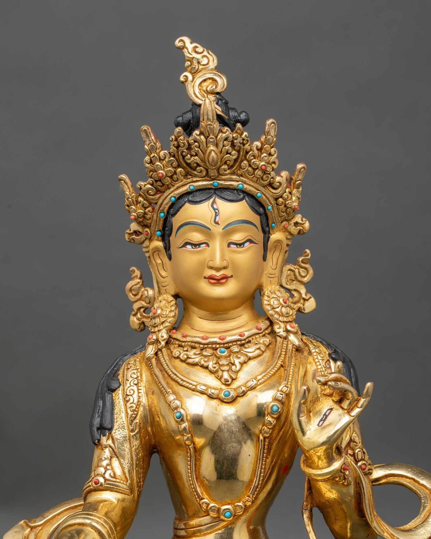 close up Dukar statue gold painted face intricate carvings semi precious stones Tibetan deity