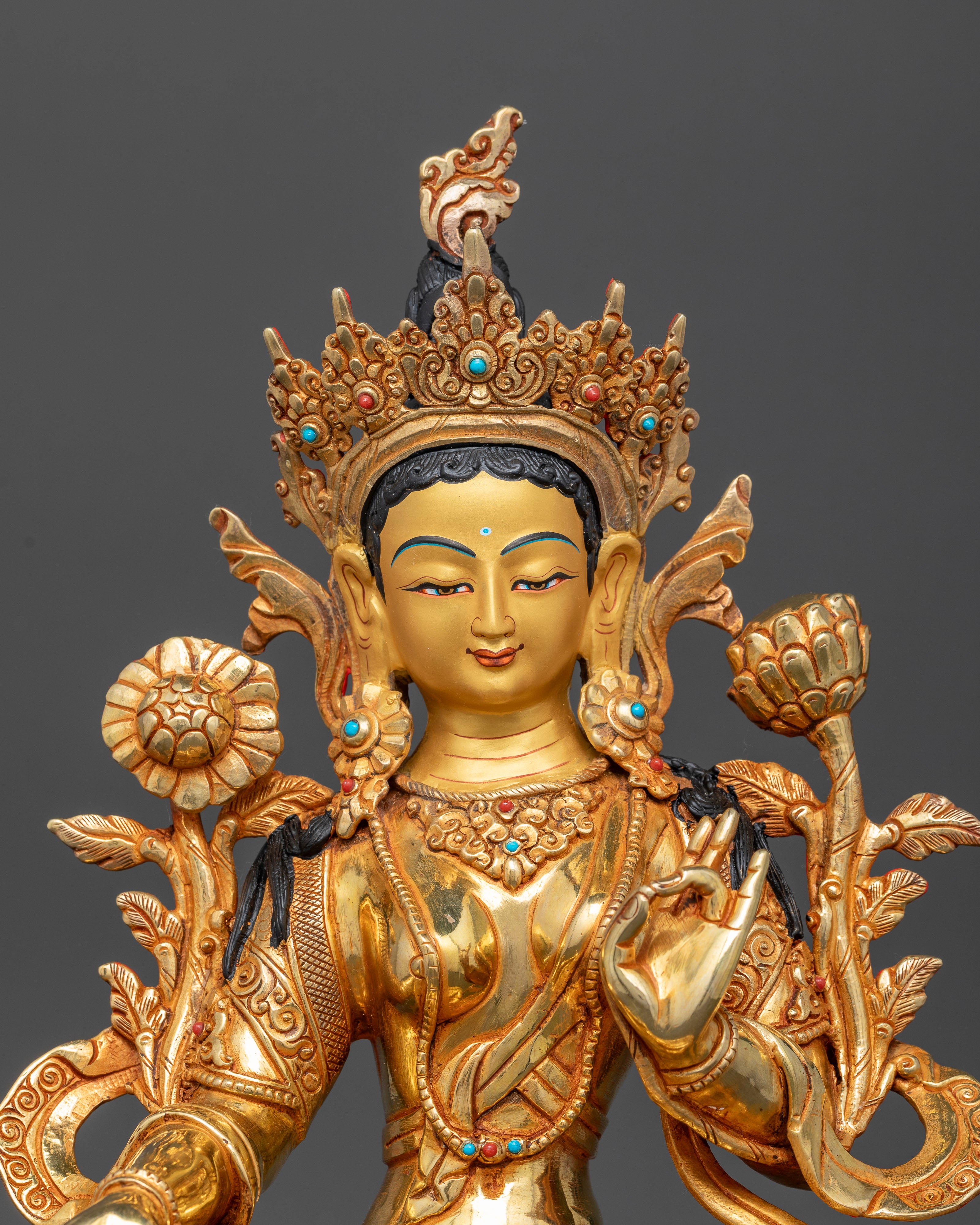 close up Green Tara statue gold painted face semi precious stones crown Himalayan Buddhist sculpture