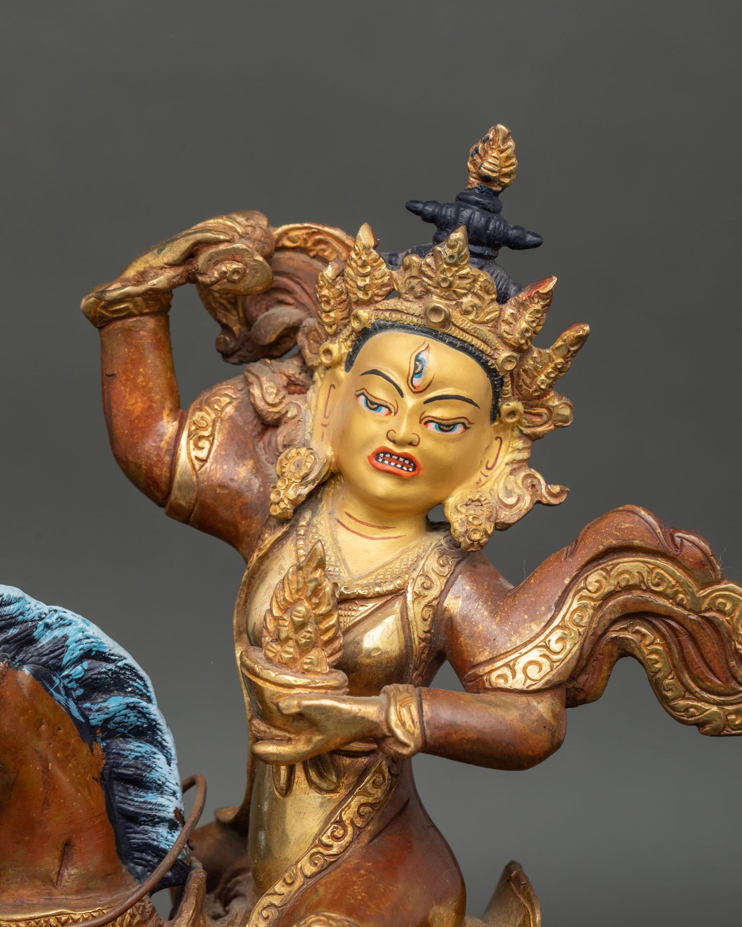 Close up Achi Chokyi Drolma statue detail gold painted face protector deity Newari artisan craftsmanship