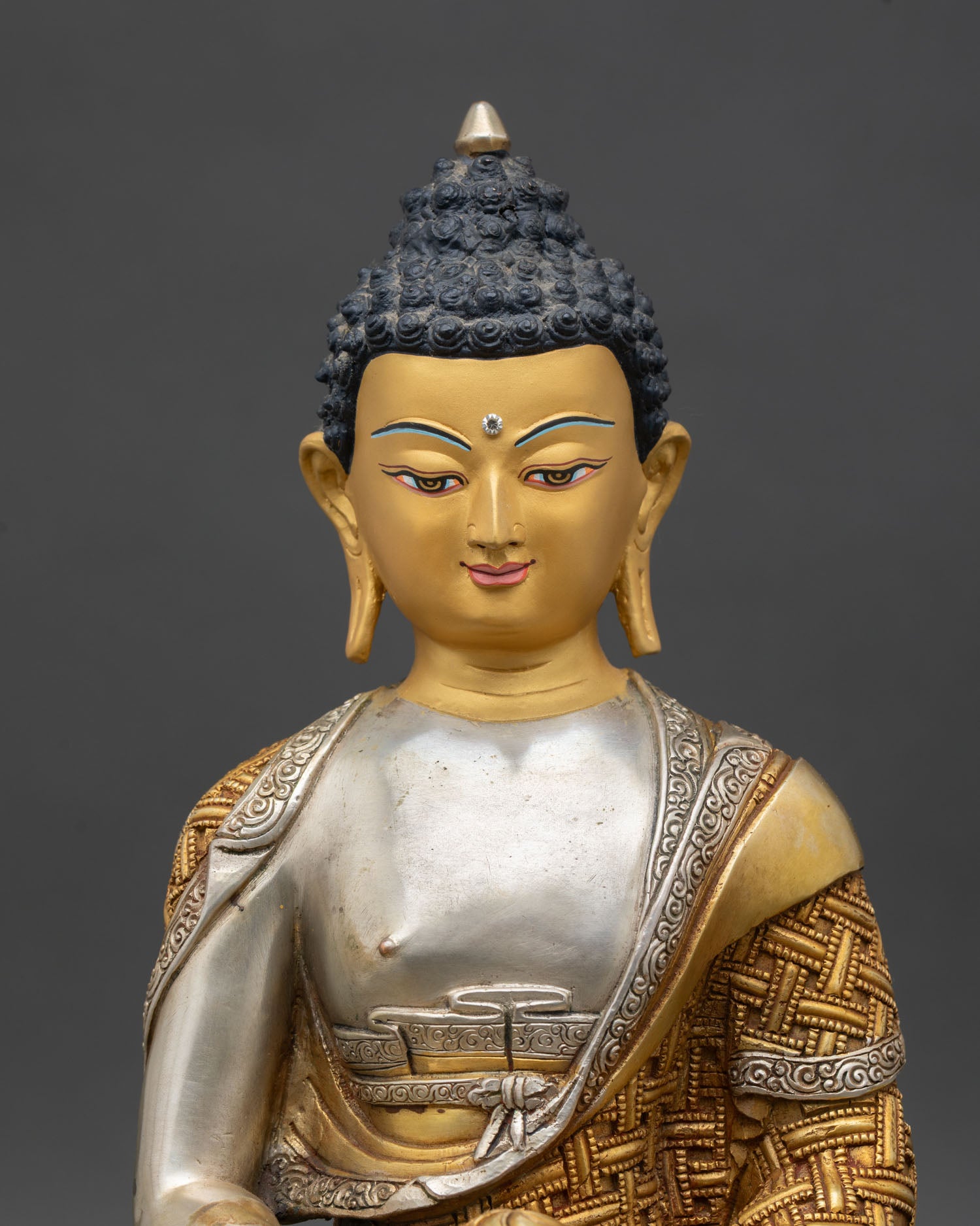 Close up Amitabha Buddha face gold painted serene expression handcrafted Nepal
