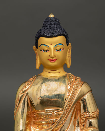 Close up Amitabha Buddha gold painted face with meditation mudra and alms bowl