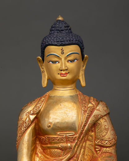 Close up Amitabha Buddha statue showing copper craft, gold gilding and robe detailing
