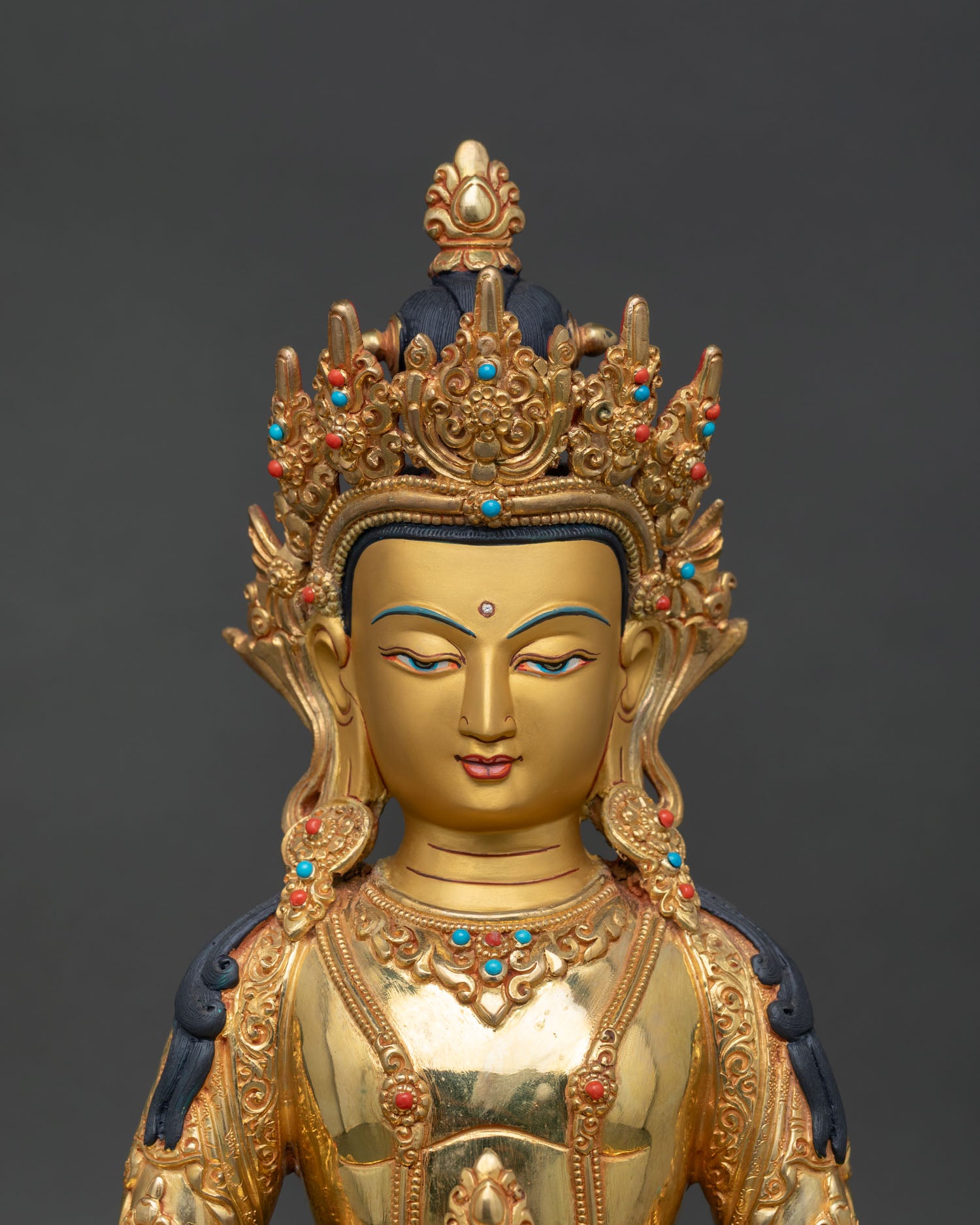 close up Amitayus sculpture handcrafted Nepal copper statue with gold fire gilding and intricate detailing