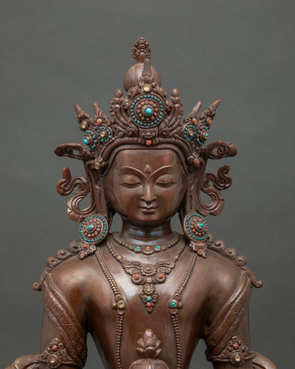 Close up Amitayus statue showing ornate jewel crown semi precious stones and celestial jewelry.