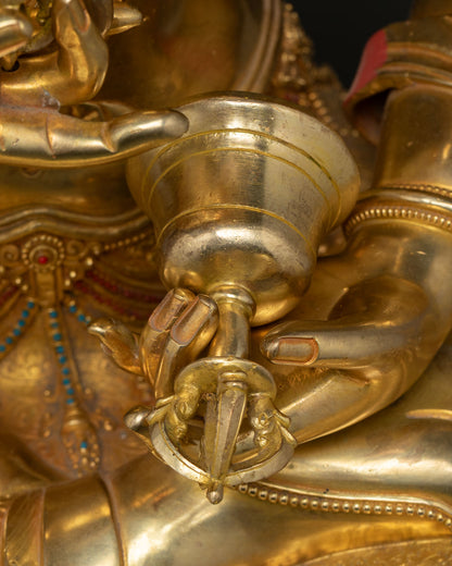 Close-up bell ghanta held in Vajrasattva right hand copper gold 24K gilded detail Nepal