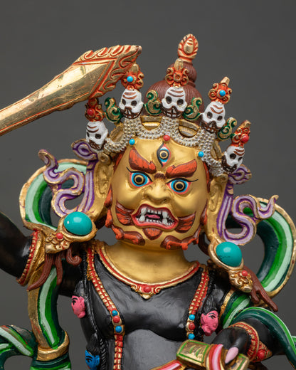 Close up Black Manjushri face with gold paint, third eye and five skull crown detail